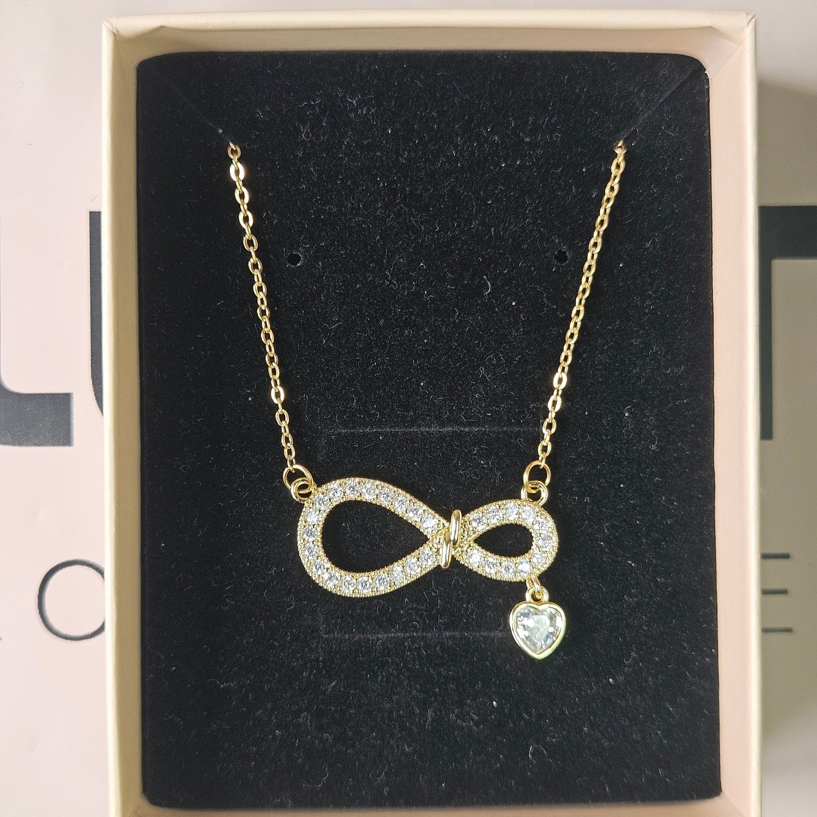 Studded Infinity Pendant with a Dangling Heart Charm Necklace